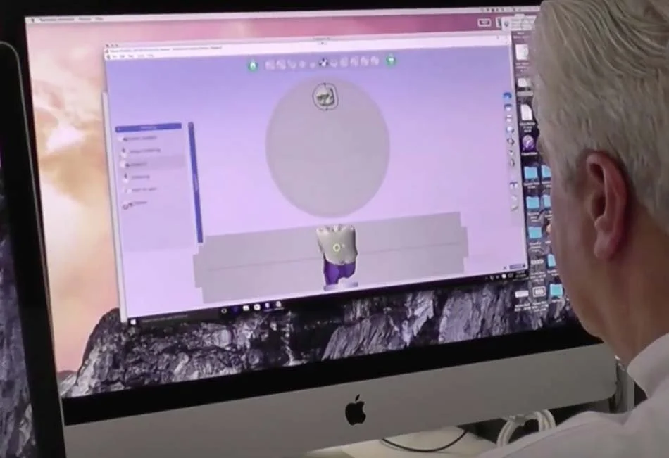 Lab technician designing a restoration in dental CAD software